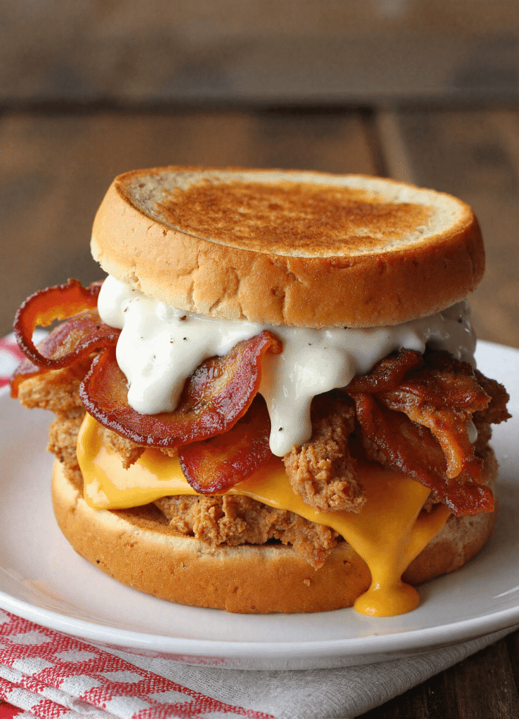 Grilled crispy bacon and ranch chicken melt sandwich with cheddar cheese and ranch sauce on toasted white bread.