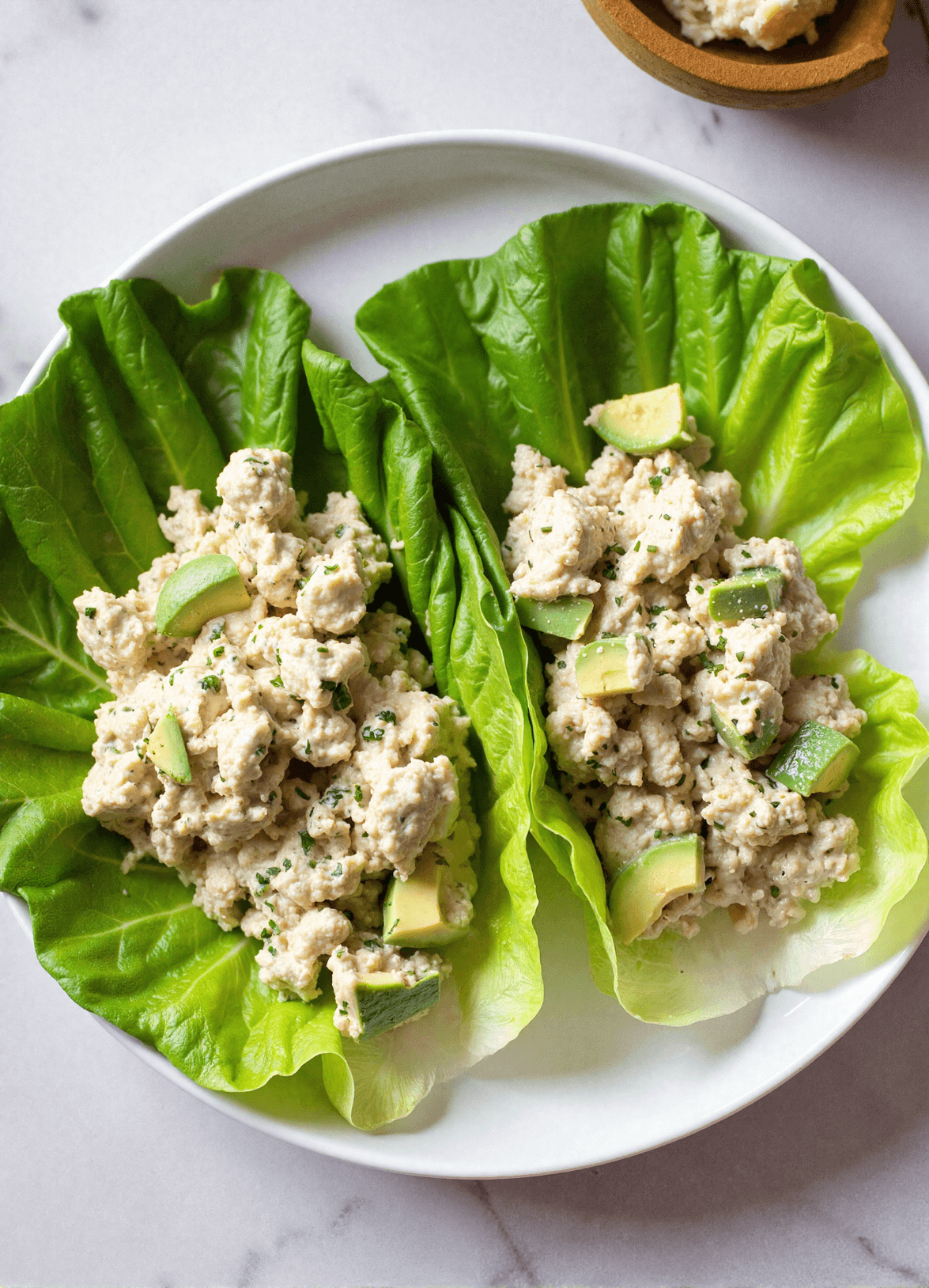 Avocado chicken salad lettuce wraps with creamy avocado and tender chicken breast in crisp butter lettuce cups, perfect for low carb chicken wraps.