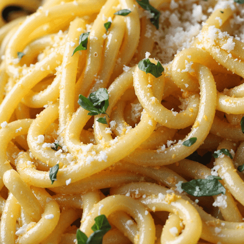Close-up of garlic butter pasta topped with parmesan cheese and chopped parsley