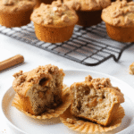 Close-up of apple Greek yogurt muffins with cinnamon crumble, halved to show texture and filling.