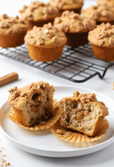 Close-up of apple Greek yogurt muffins with cinnamon crumble, halved to show texture and filling.