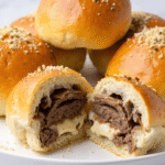 Golden baked cheeseburger bombs filled with ground beef and melted cheese, topped with garlic Parmesan crumbs.