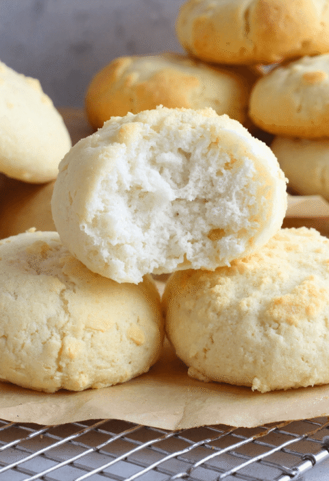 Soft and fluffy cottage cheese cloud bread with a light, airy center and golden edges on parchment paper.