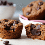 Moist chocolate chip oatmeal muffins made with Greek yogurt, one cut open to show soft, rich interior and melted chips.