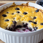 High protein blueberry cottage cheese breakfast casserole baked with fresh blueberries in a white dish.